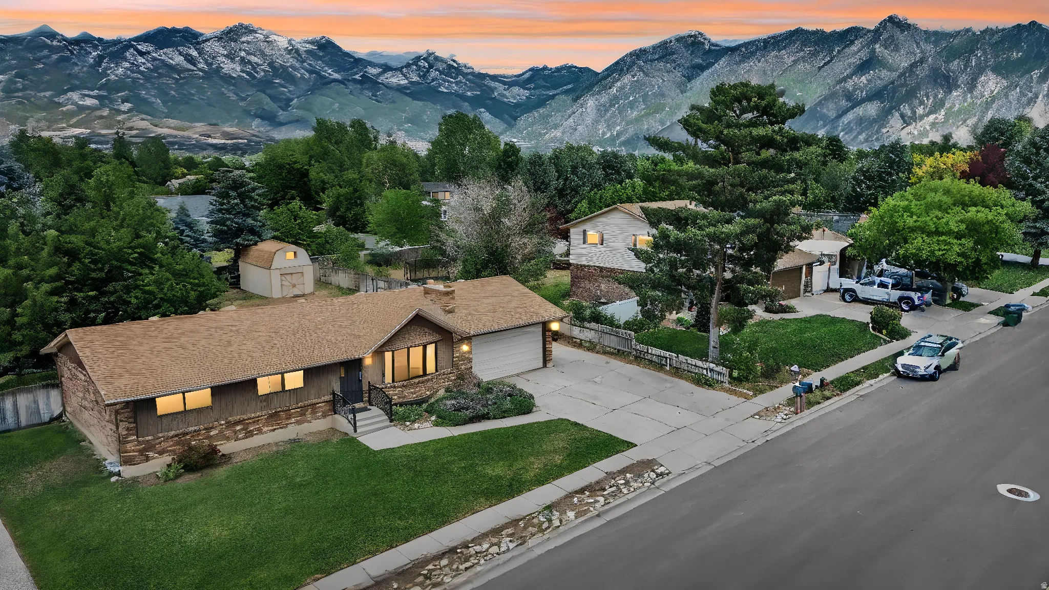 Single-story residence featuring stone and horizontal siding, an attached garage, and a lush green lawn