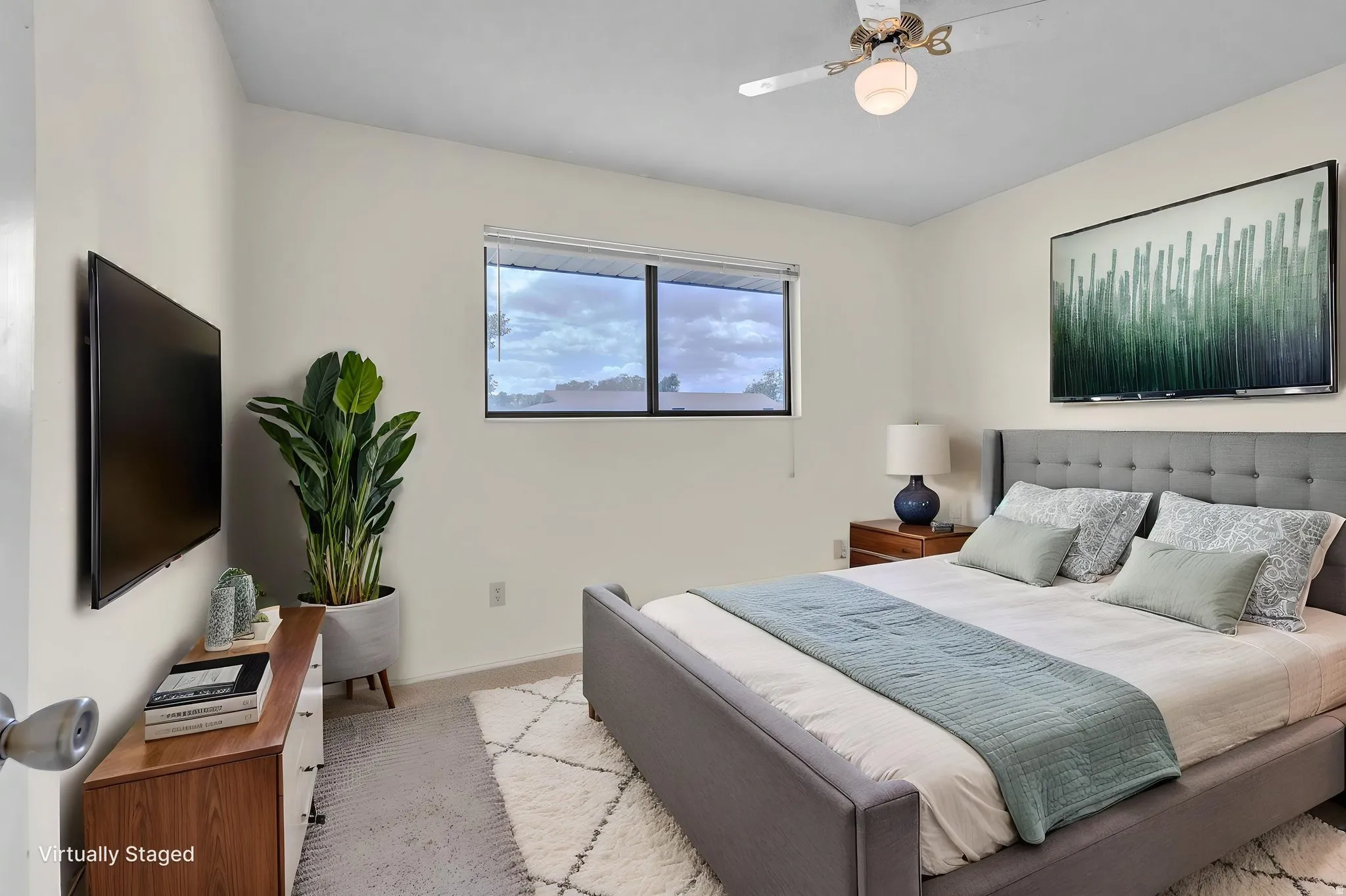 Virtually Staged -Carpeted bedroom featuring a built-in window, a ceiling fan with integrated lighting, and neutral wall tones