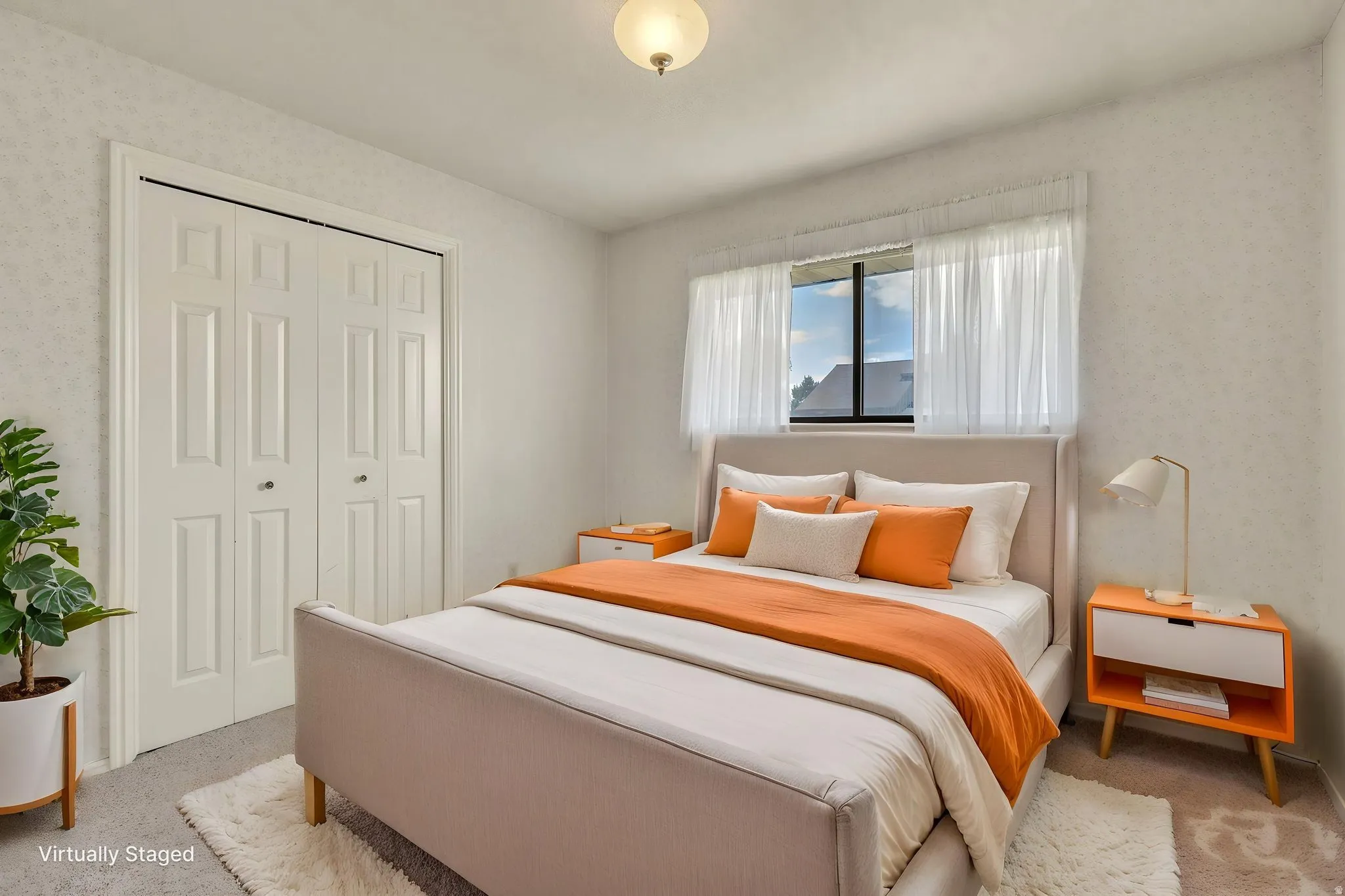 Virtually Staged -Carpeted bedroom featuring a double window with sheers, a light fixture, and bifold closet doors