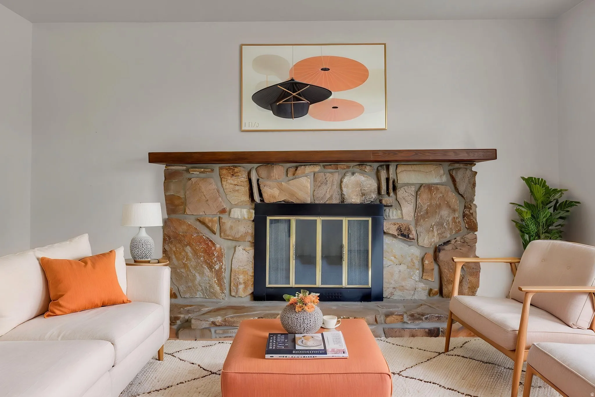 Stone fireplace with a wood mantel and black firebox