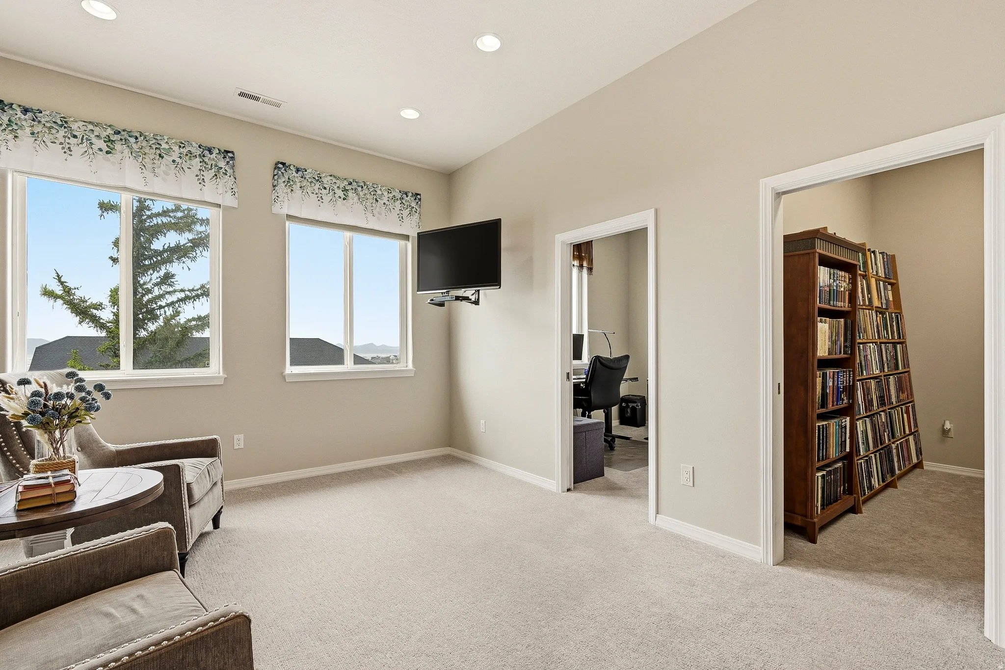 Neutral-toned walls and plush carpeting define this versatile space
