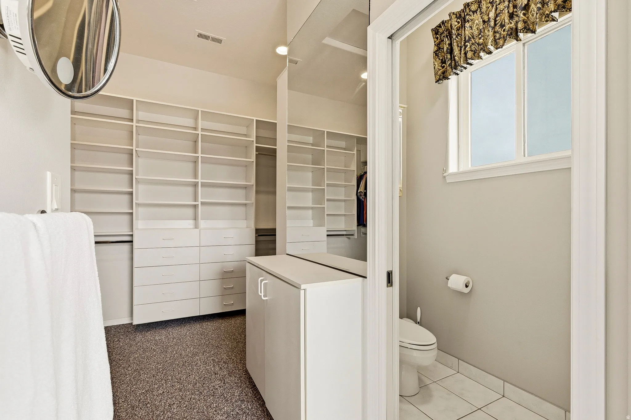 Custom closet organization system featuring extensive shelving and integrated drawers