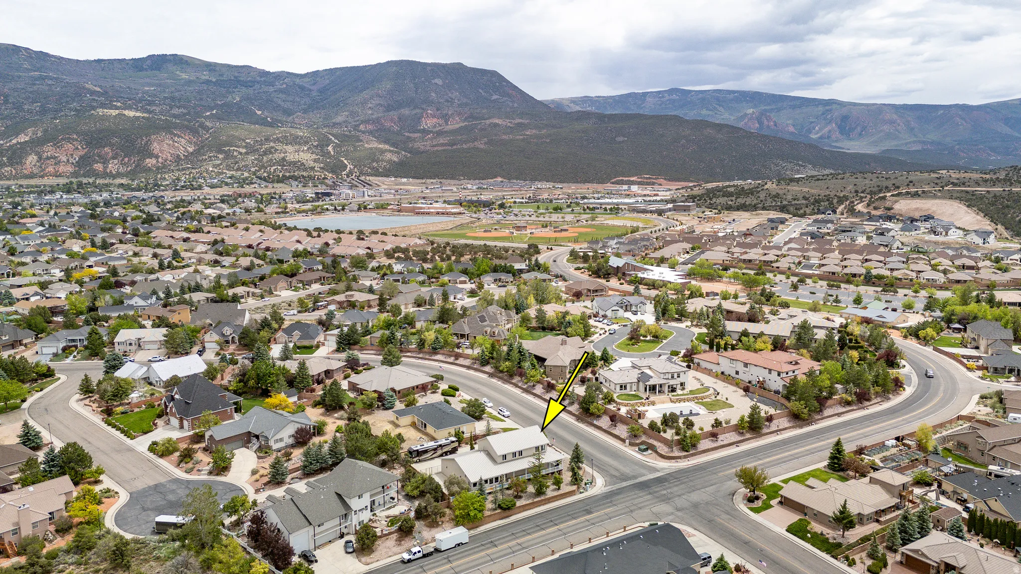 Aerial view showcasing a residential neighborhood with surrounding mountains