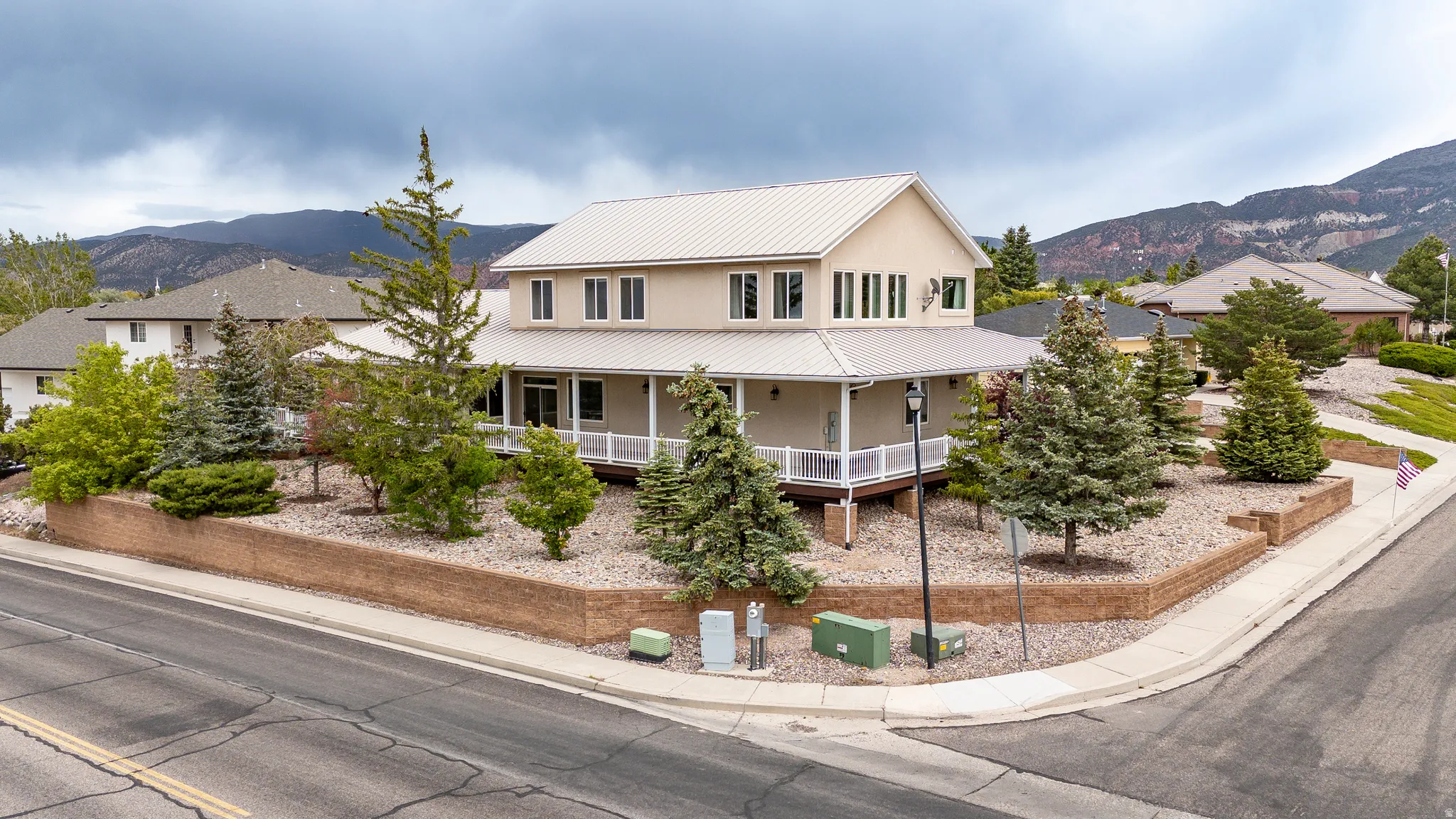 Two-story residential property with a light-colored exterior and a metal roof