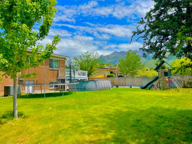 Expansive backyard featuring, above ground  pool, play/swing set. Garden boxes and back entrance to lower level
