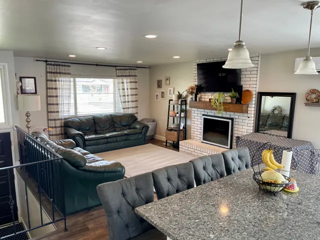 Open-concept living area with LVP flooring and recessed lighting