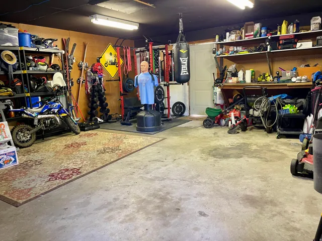 2 car garage with work benchand heavy duty shelving