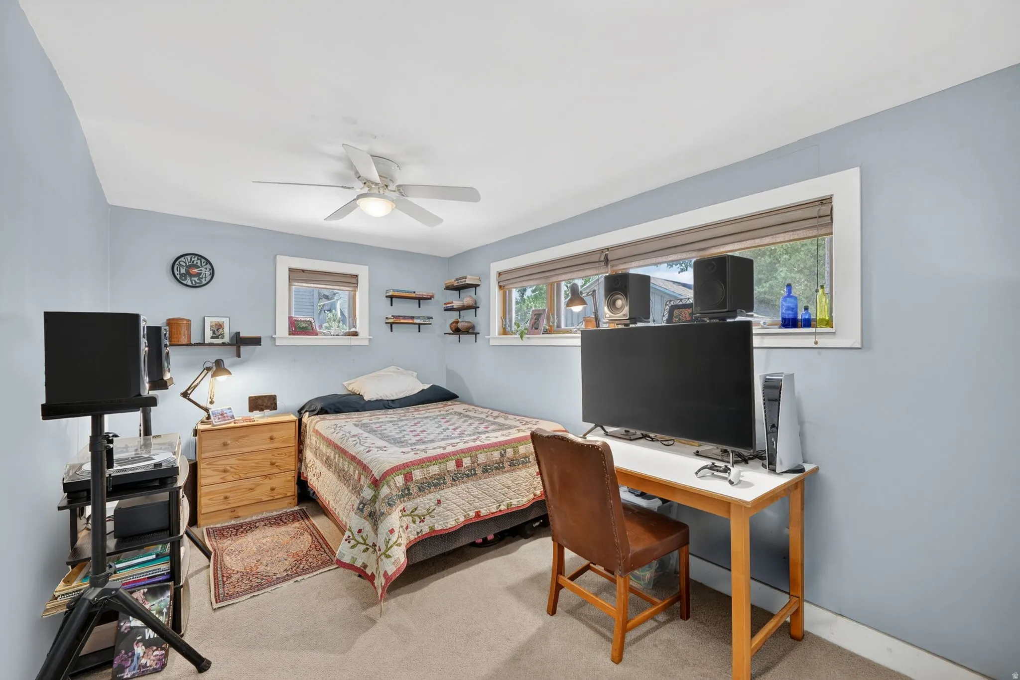 Room with light blue walls and neutral carpet flooring