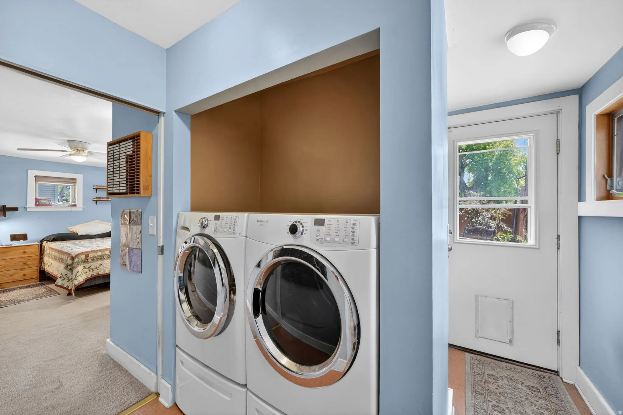 Laundry area featuring stacked front-load washer and dryer units