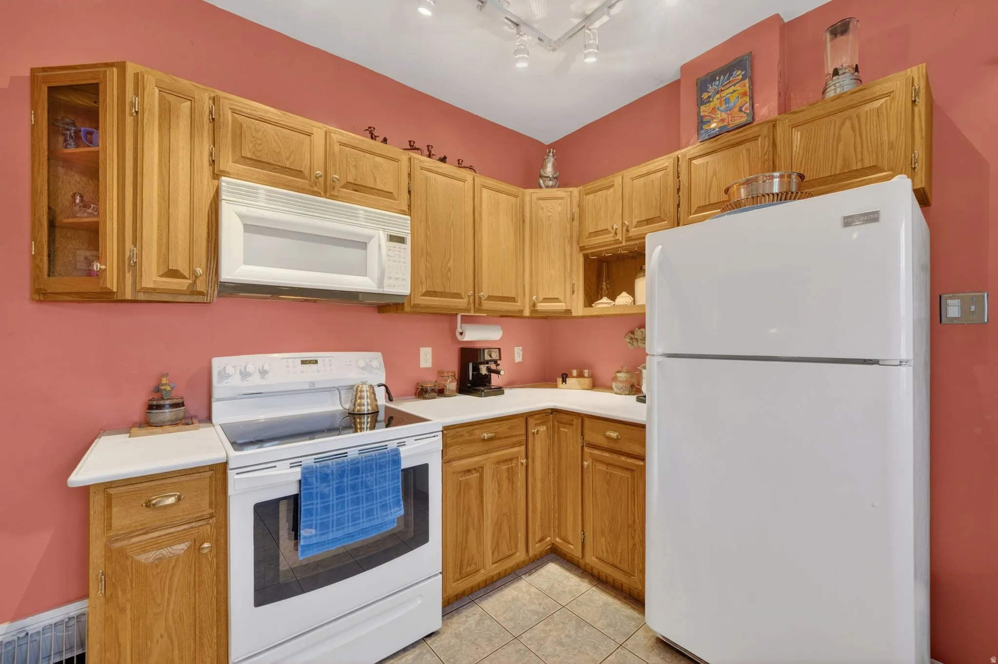 Kitchen featuring wood-finish cabinetry, white countertops, and tile flooring