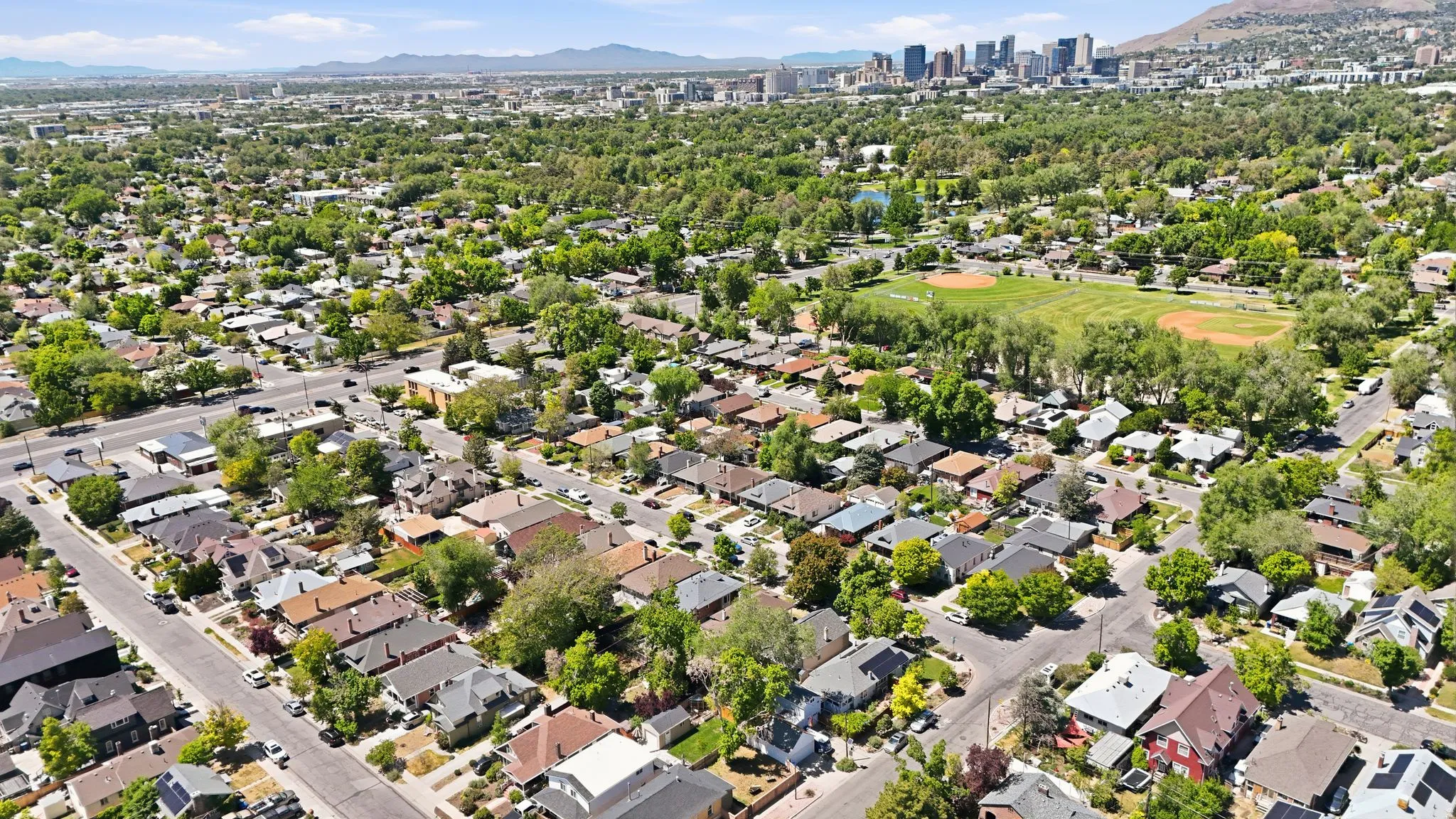 Expansive neighborhood showcasing diverse residential architecture and mature tree canopy