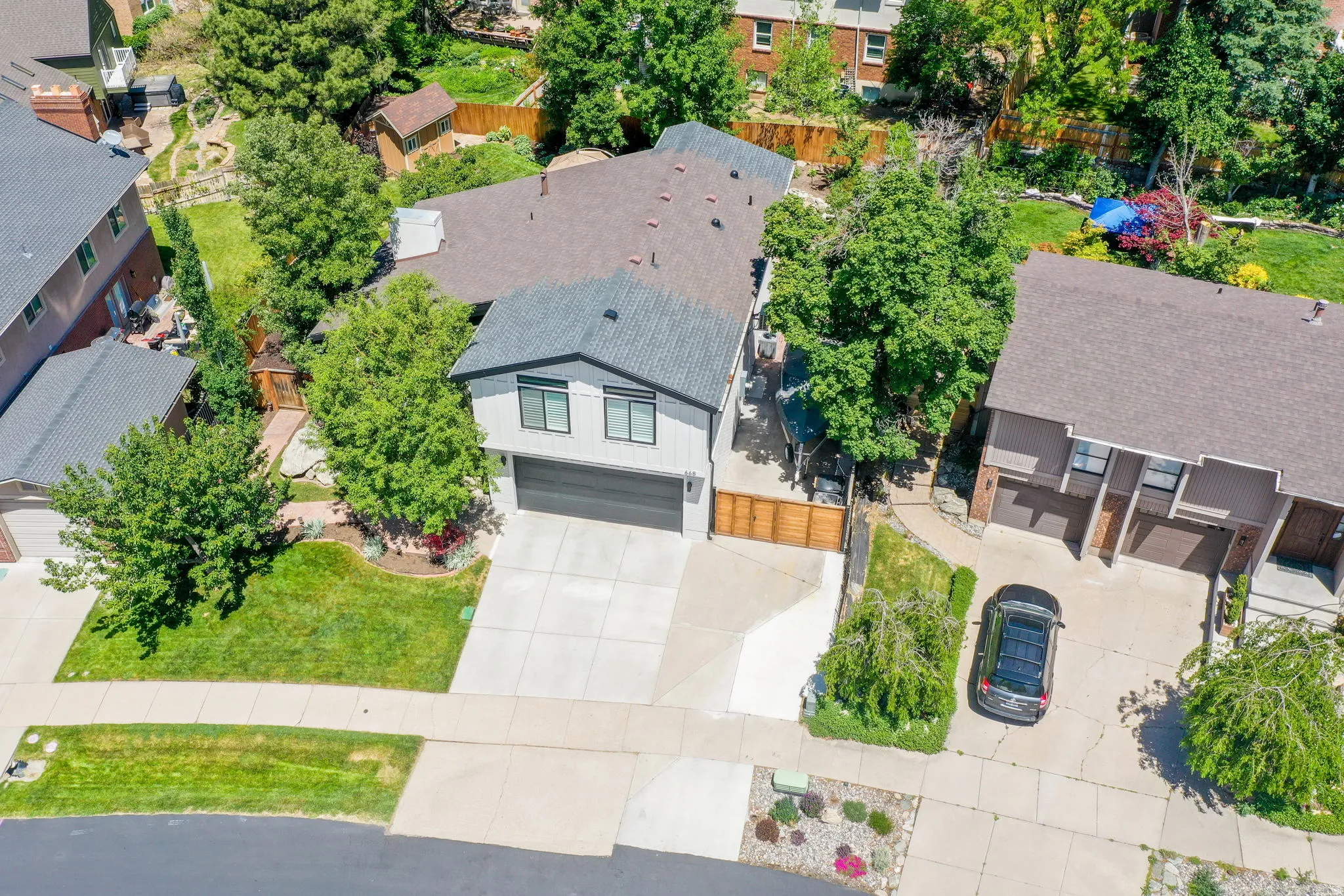Contemporary exterior with a two-car garage, concrete driveway, and front lawn