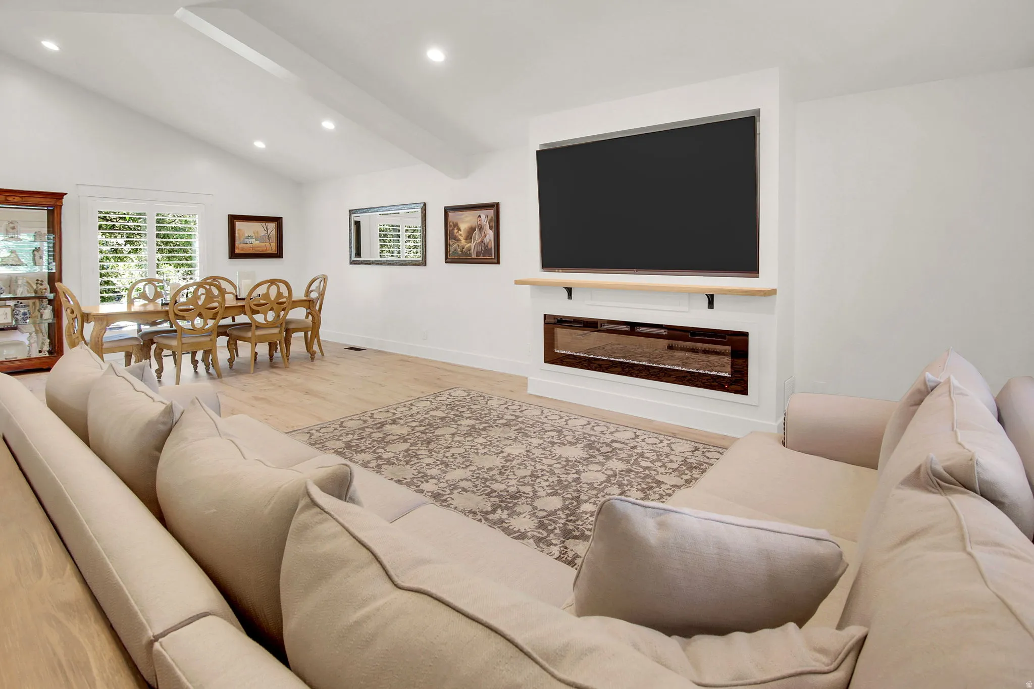 Expansive living area with vaulted ceilings and recessed lighting