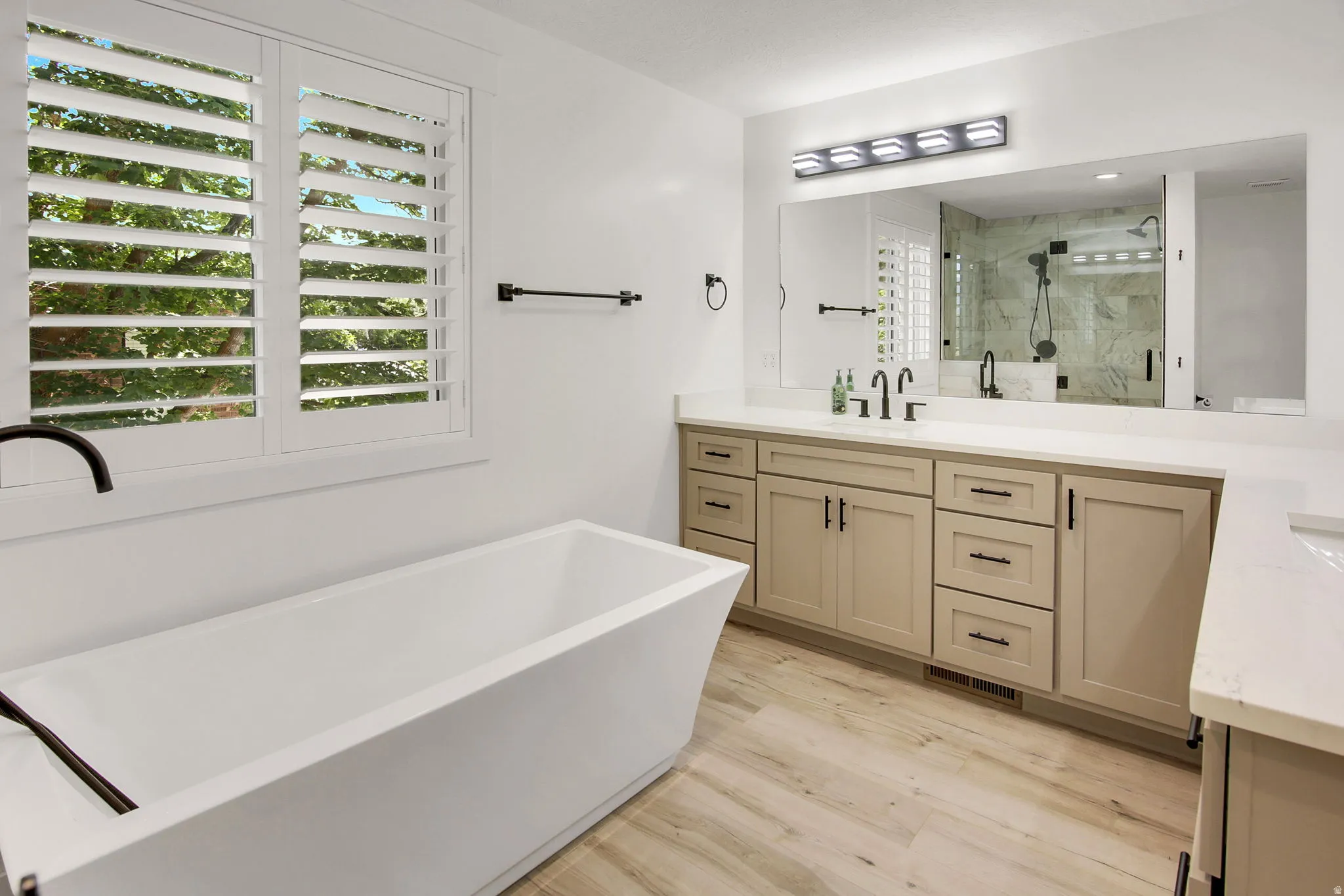 Freestanding soaking tub with dark bronze fixtures