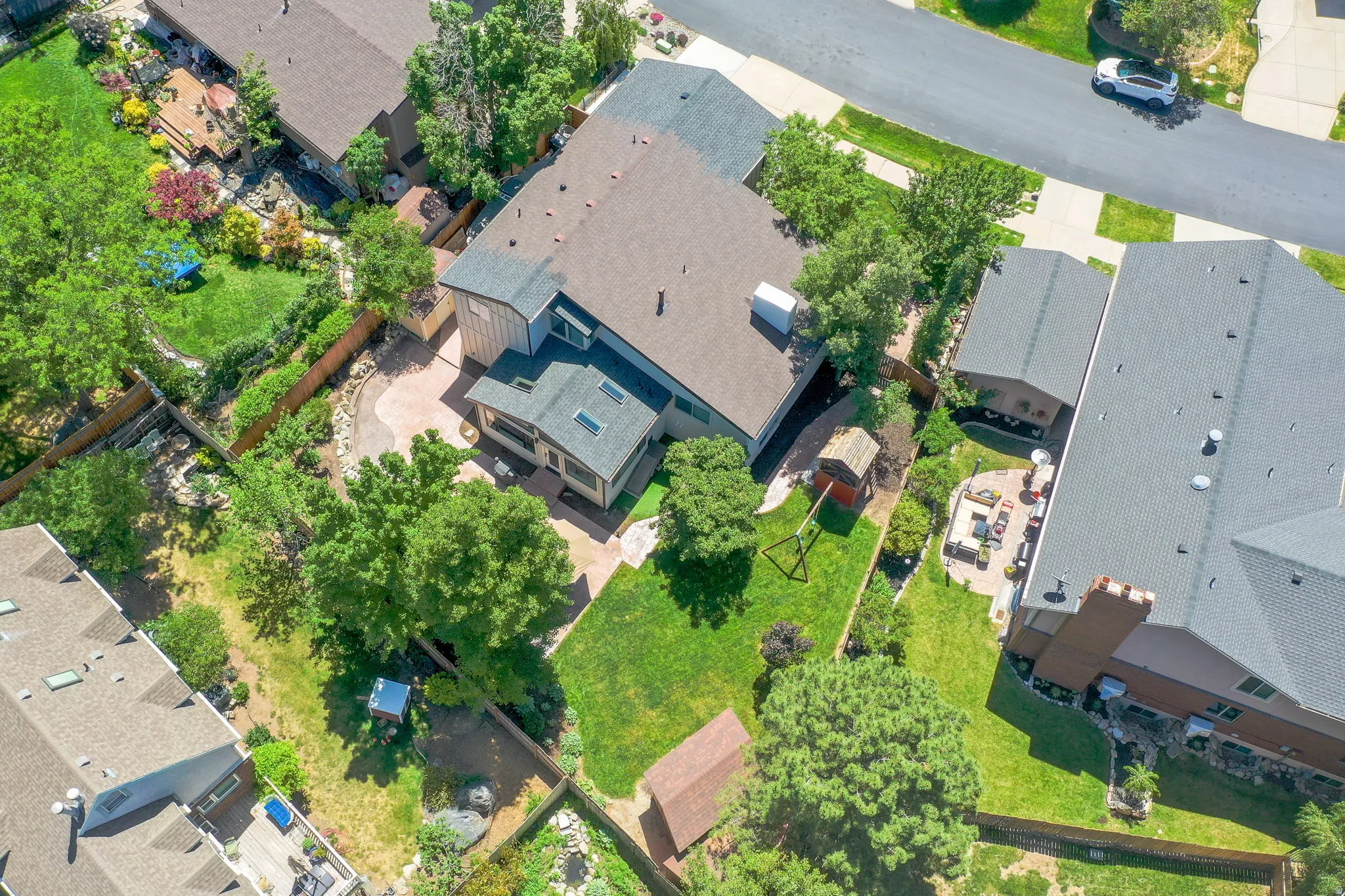 Expansive property featuring a multi-level roofline, skylights, and a detached structure