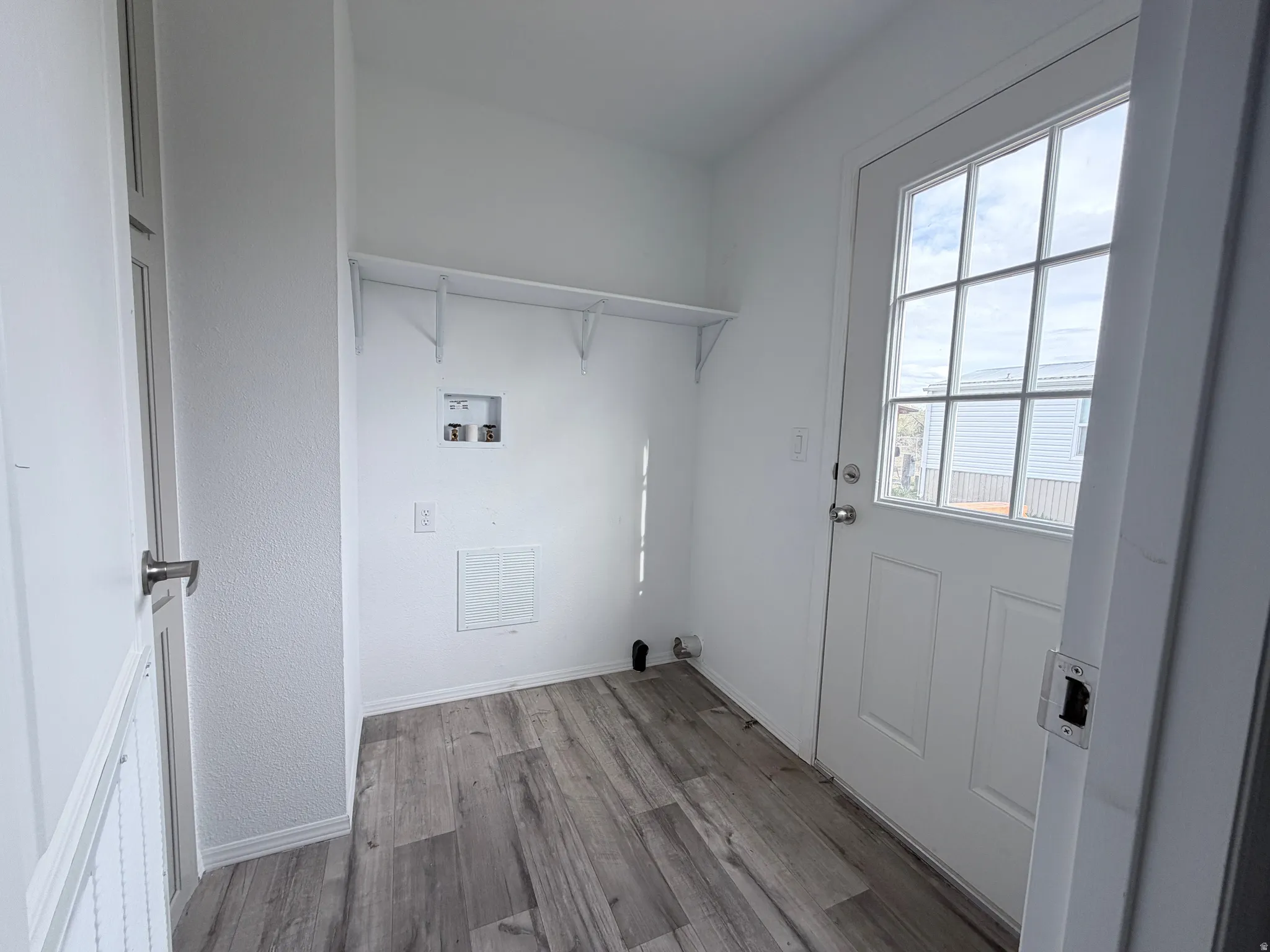 Spacious laundry room with door access to the back yard