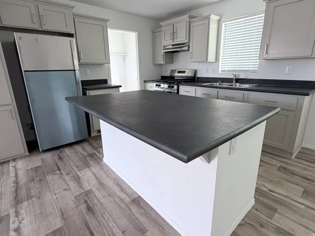 Kitchen Island featuring dark countertop