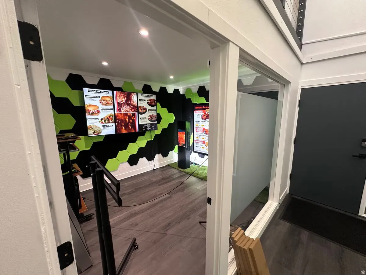 Room featuring a distinctive black and green hexagonal wall treatment