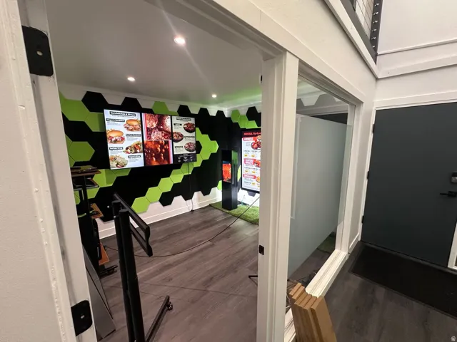Room featuring a distinctive black and green hexagonal wall treatment
