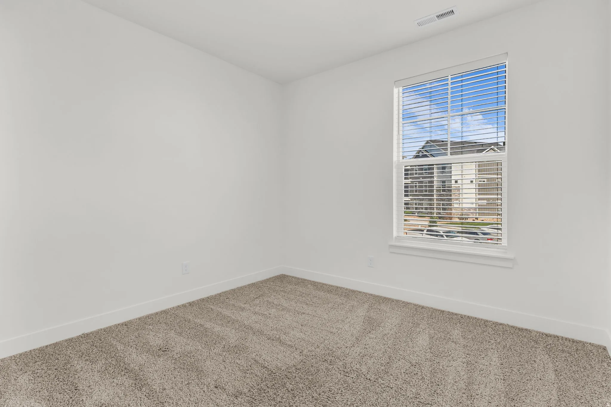 Room featuring light gray carpet, white walls, and white baseboards
