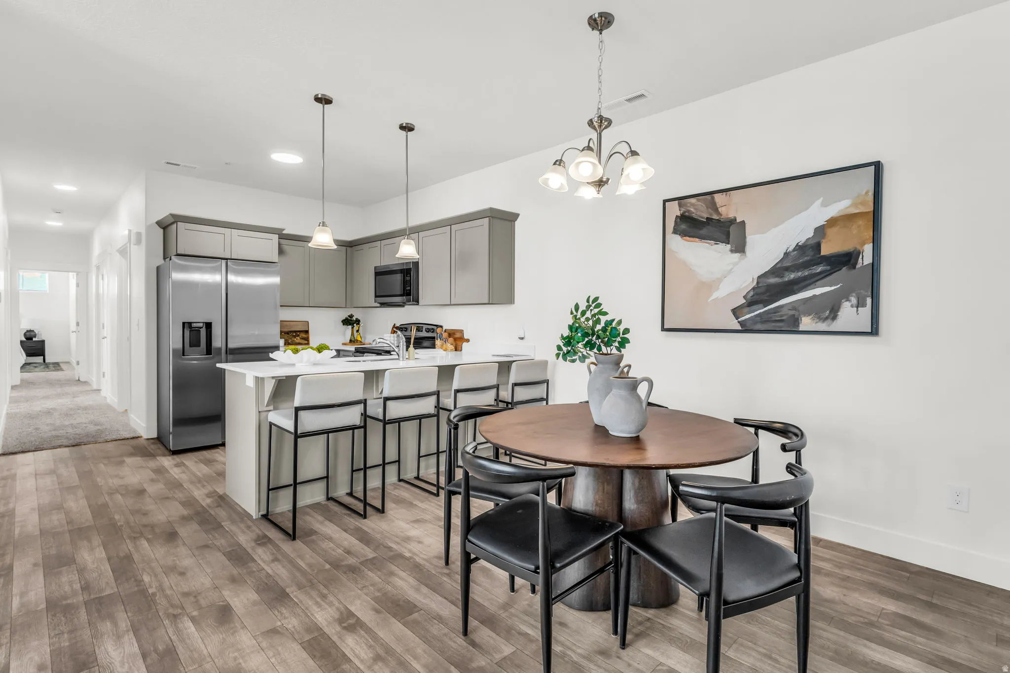 Open-concept kitchen and dining area featuring wood-finish flooring