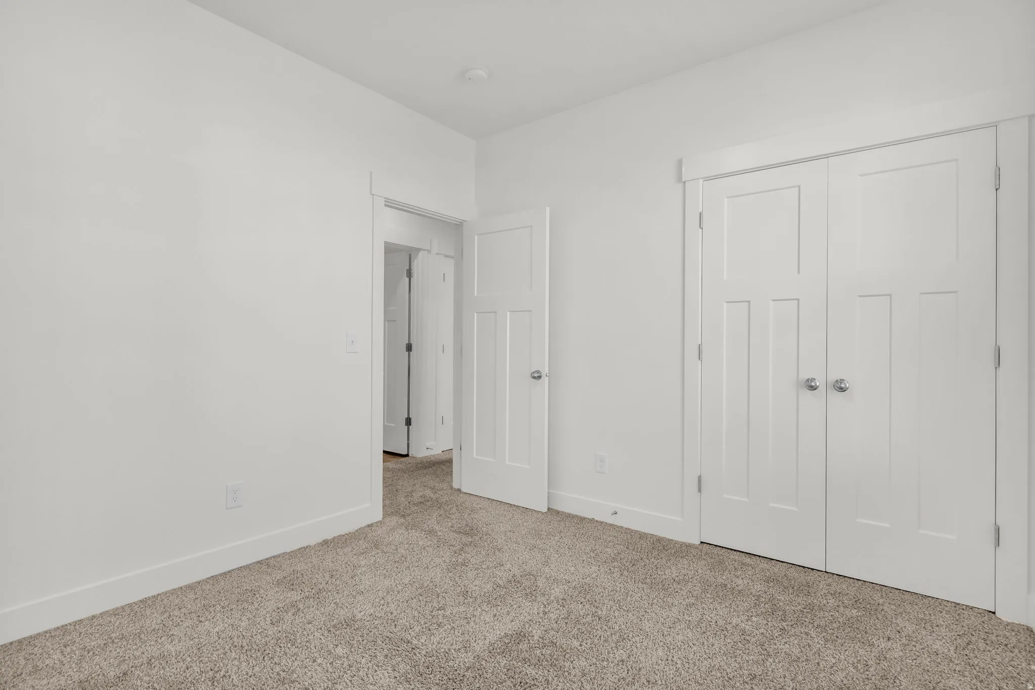 Neutral-toned carpet flooring complements crisp white walls and trim