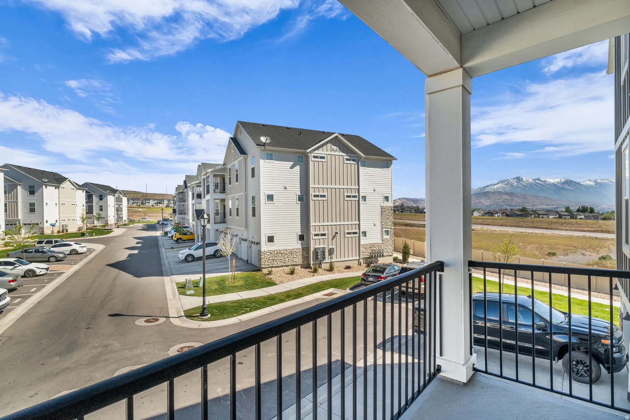 Balcony overlooking a residential street with mountain scenery