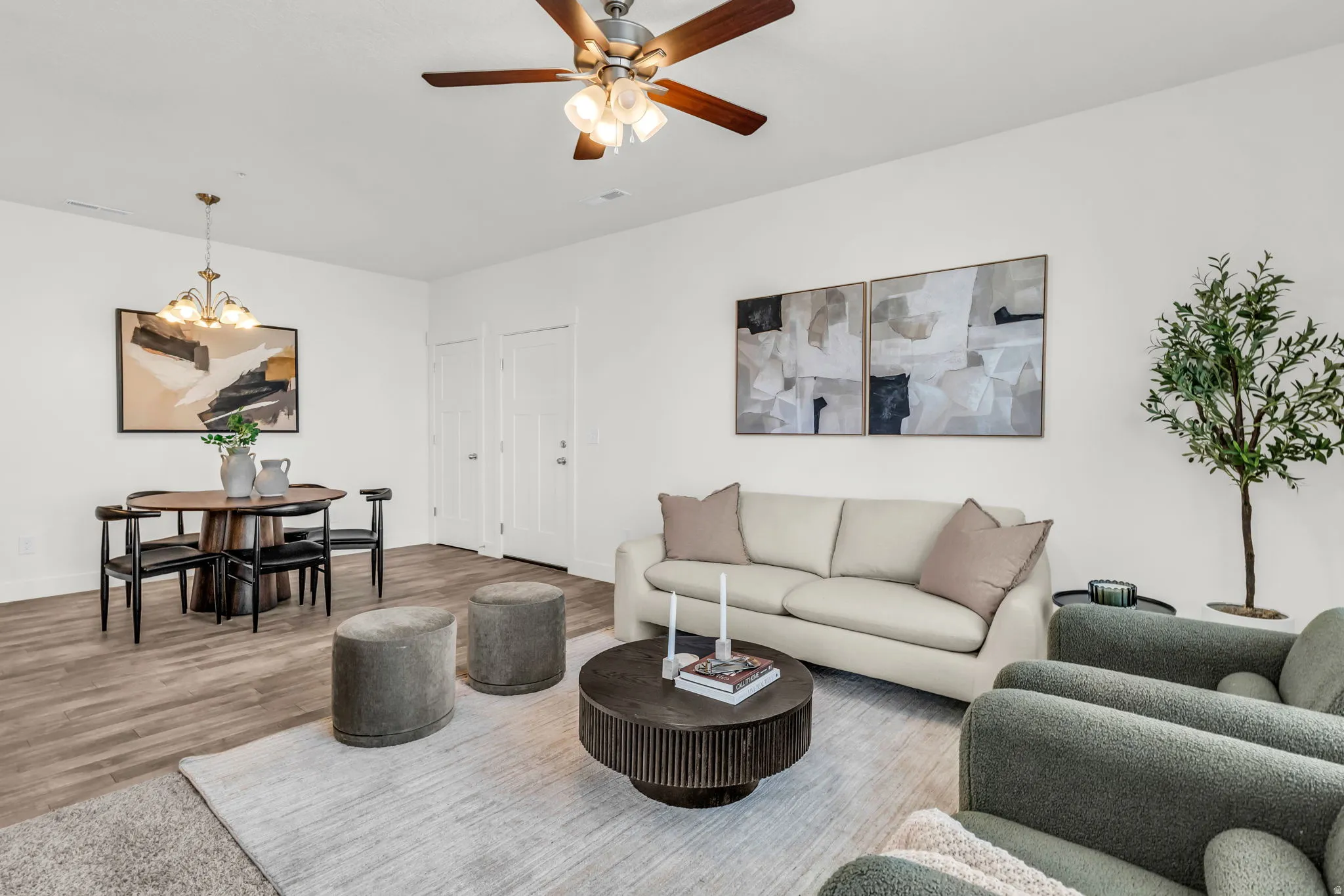 Open-concept living area with wood-finish flooring, a contemporary ceiling fan, and recessed lighting