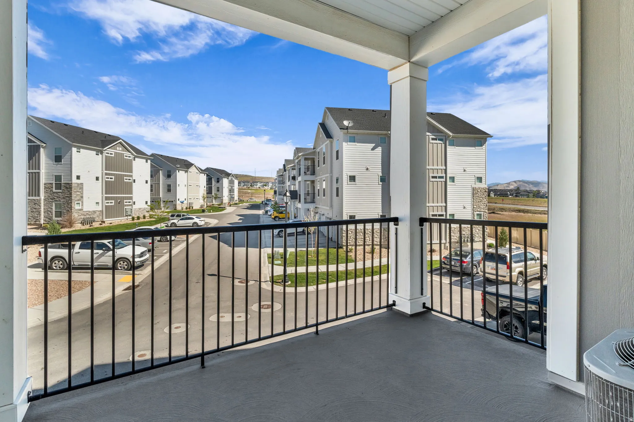 Private balcony featuring a concrete floor and black metal railing