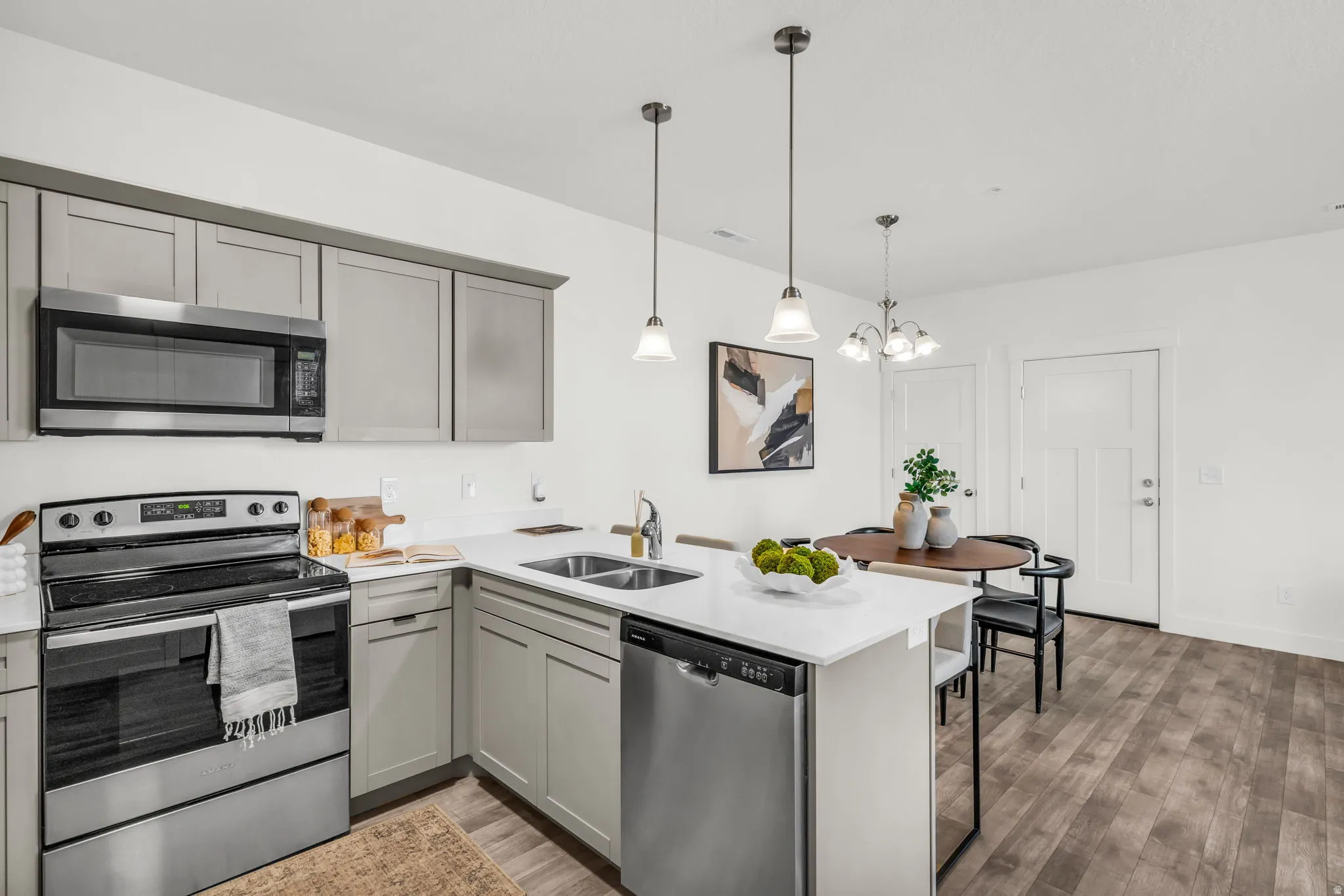 Modern kitchen featuring light gray cabinetry and stainless steel appliances
