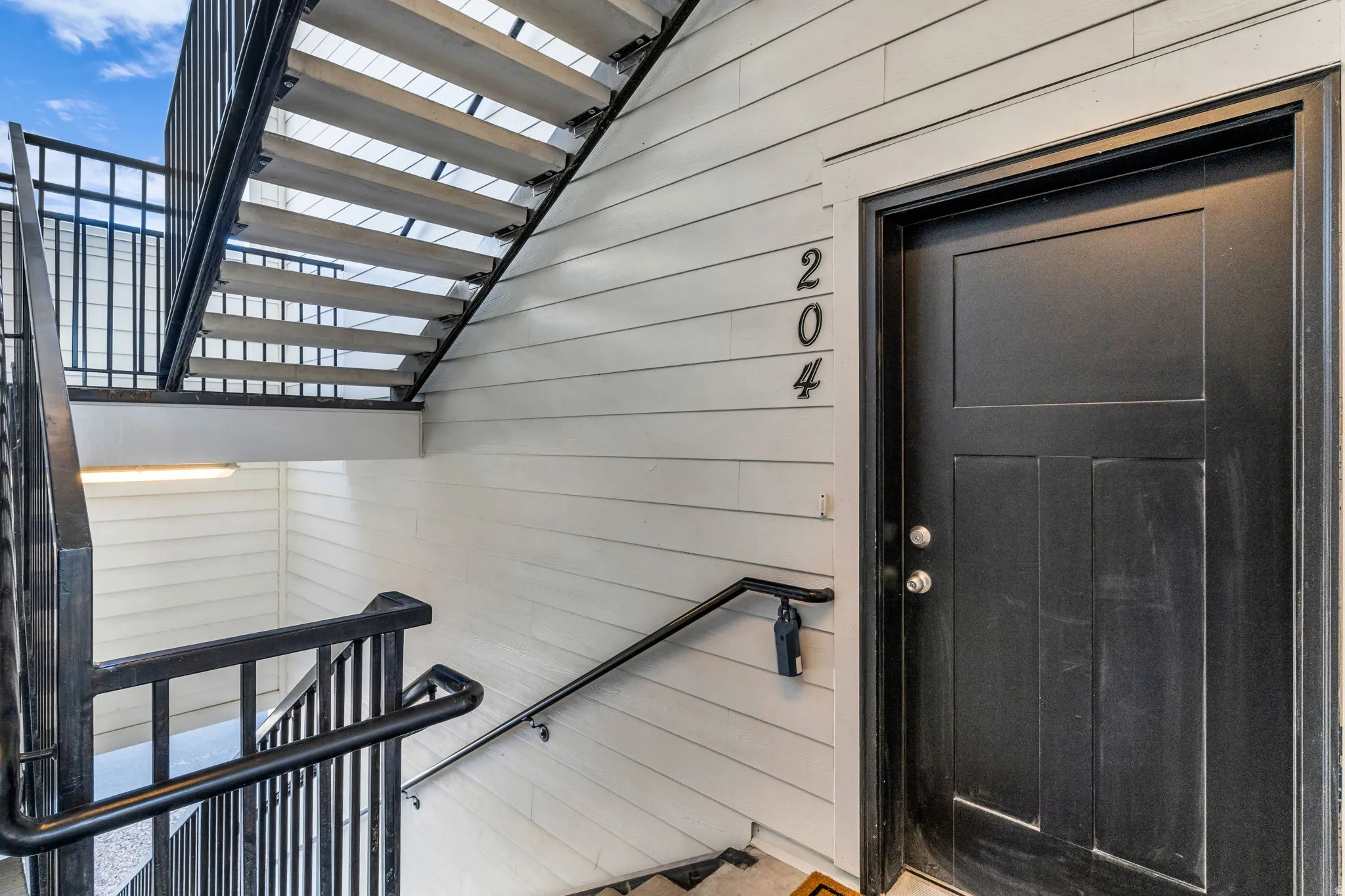 Black paneled entry door with satin nickel hardware