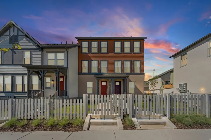 Multi-story townhome residences featuring diverse architectural styles and exterior finishes