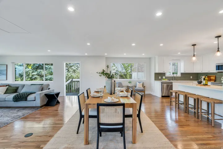 Open-concept living space featuring wood-finish flooring, recessed lighting, and ample natural light from multiple windows