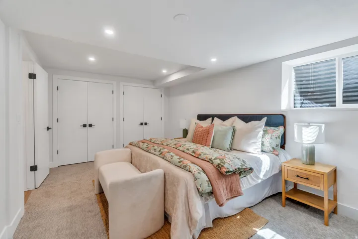 Carpeted room with recessed lighting and a window featuring horizontal blinds