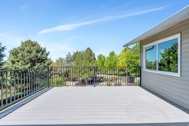 Expansive deck featuring composite decking and a black metal railing