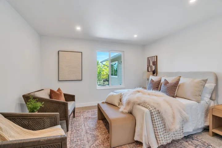 Recessed lighting illuminates the neutral-toned room