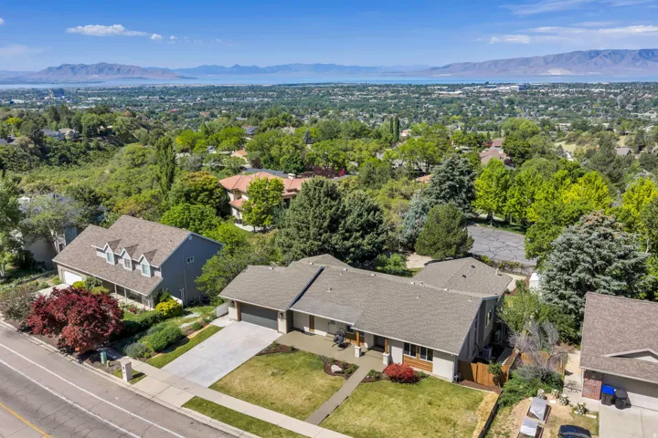 Aerial perspective showcasing a residential property with a multi-gabled roofline and attached two-car garage