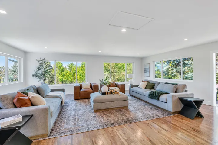 Spacious interior featuring wood-finish flooring, recessed lighting, and white walls