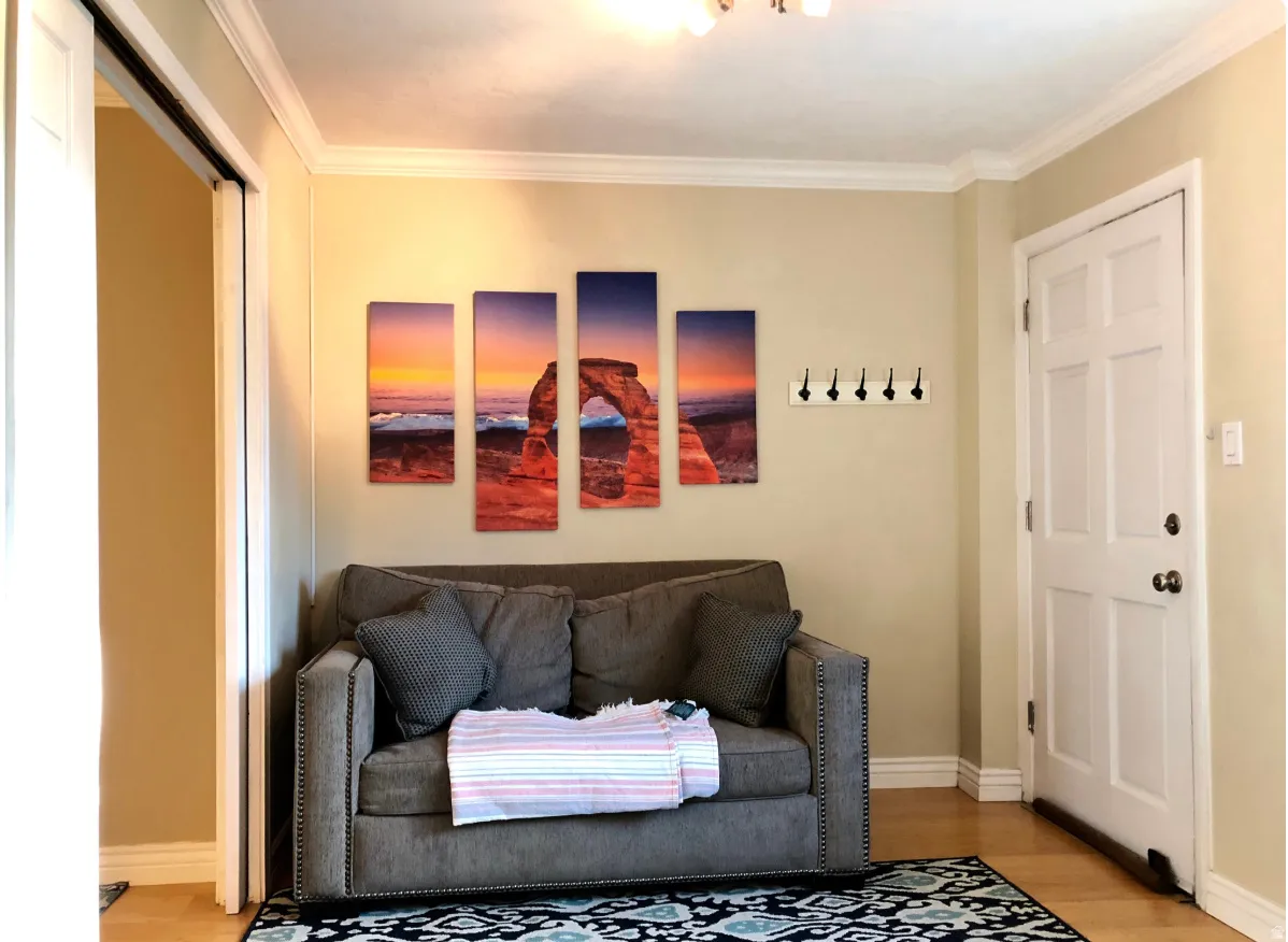 Neutral wall tones featuring white crown molding and baseboards