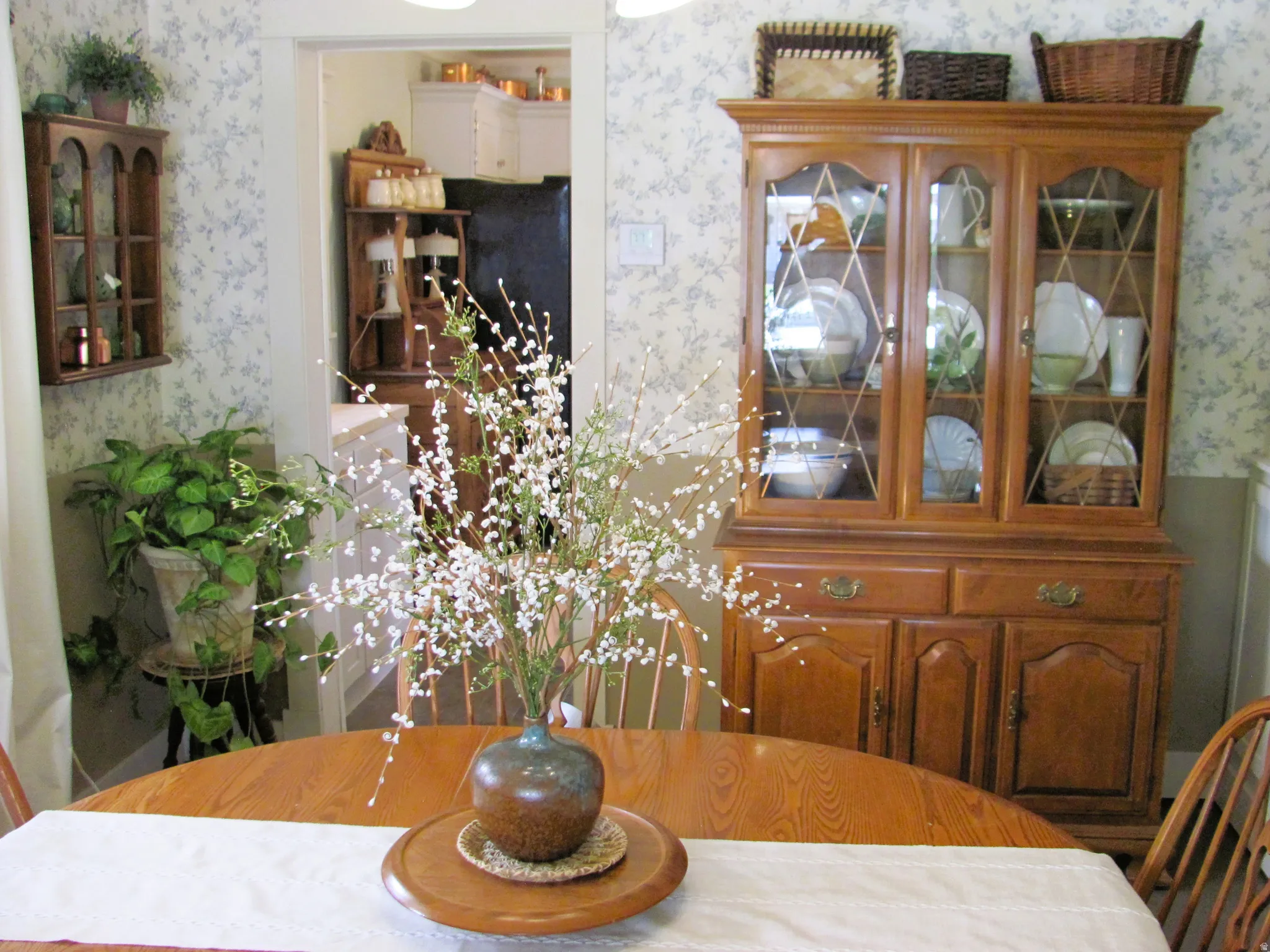 Wood-finish dining table with a light-colored table runner