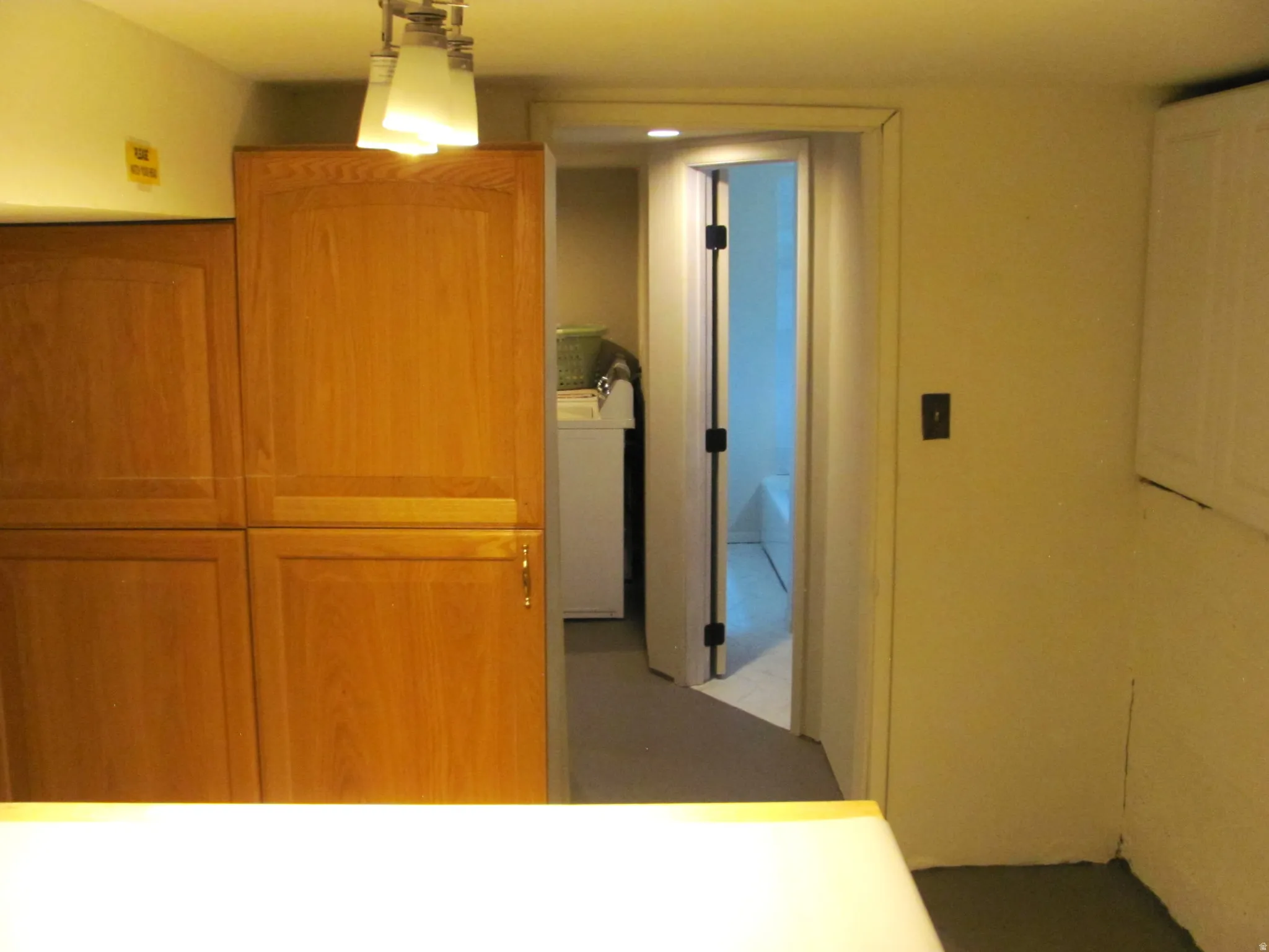 Full-height wood-finish cabinetry featuring recessed panel doors and gold-tone hardware