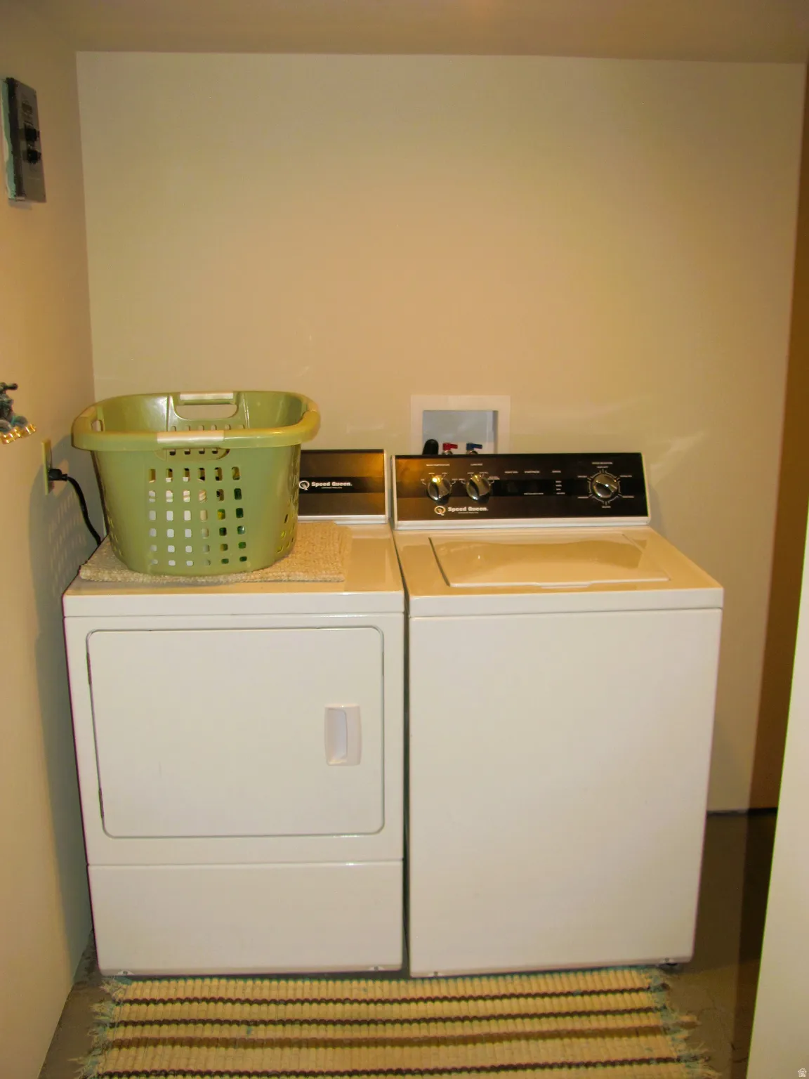 Dedicated laundry area featuring a utility sink and essential hookups for a washer and dryer