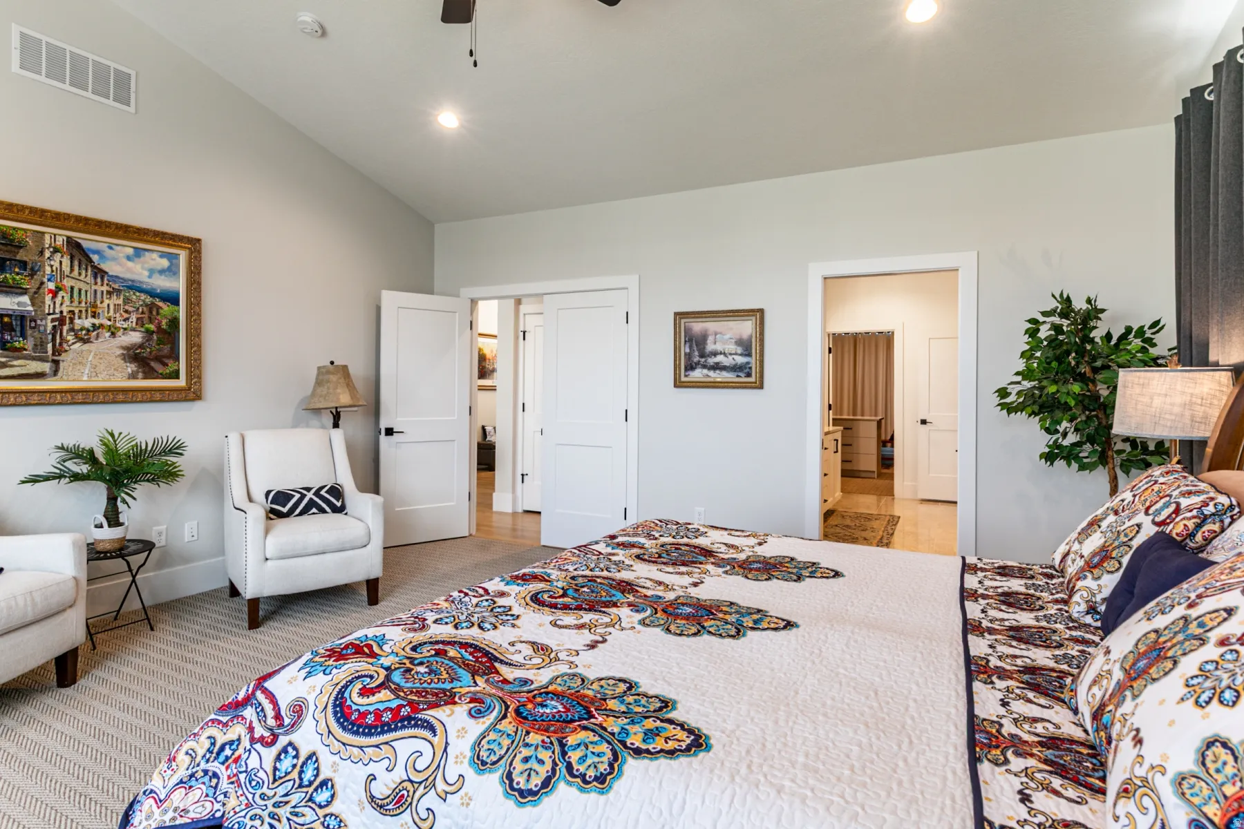 Vaulted ceiling with recessed lighting and a ceiling fan