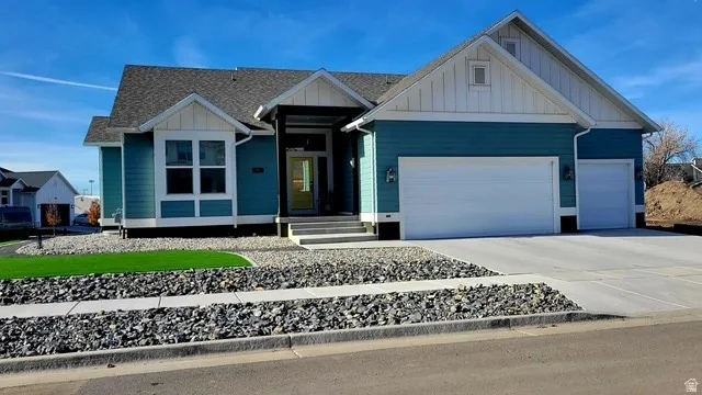 Modern ranch-style exterior with teal siding and white trim