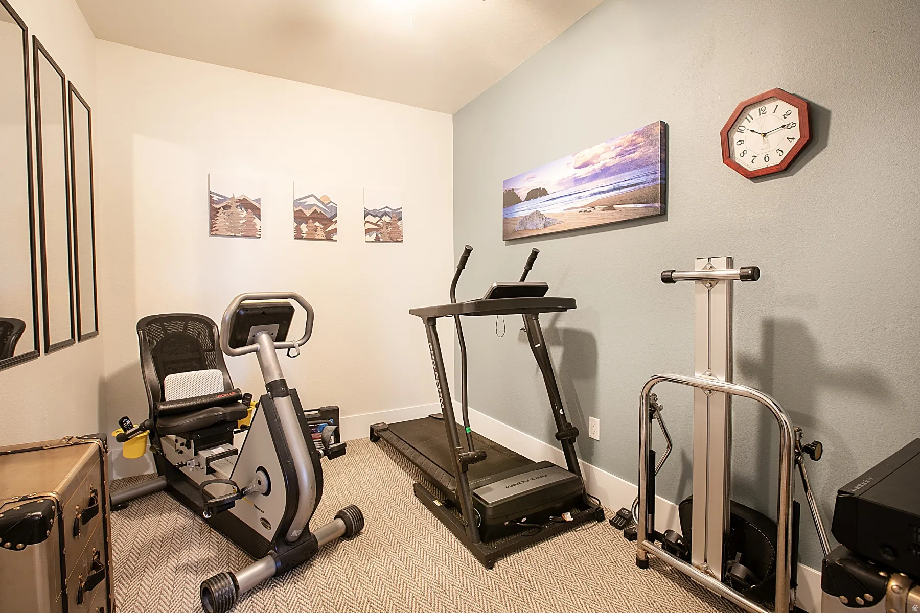 Carpeted interior room with light-colored walls and white trim