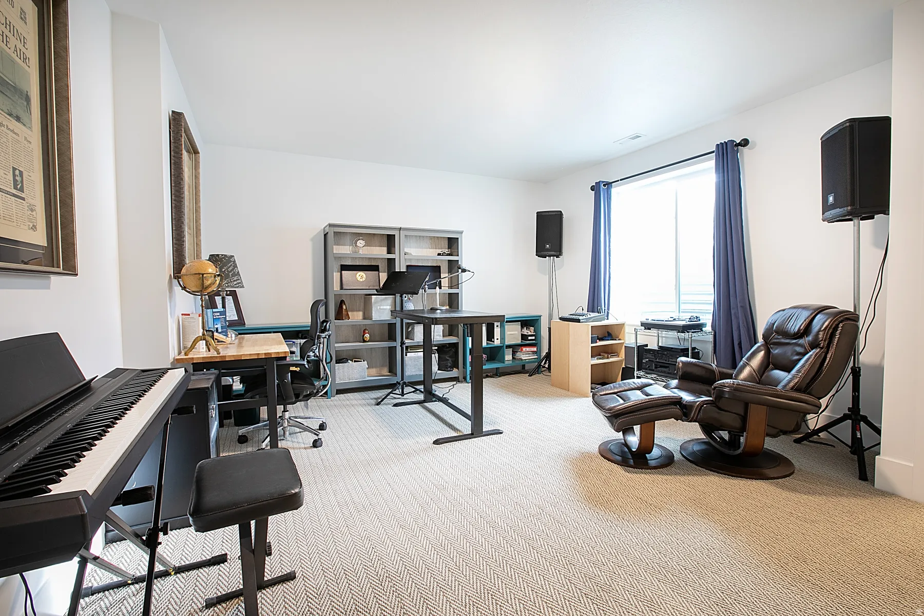 Spacious room featuring light-toned carpeting, ample natural light from a large window, and recessed ceiling lighting
