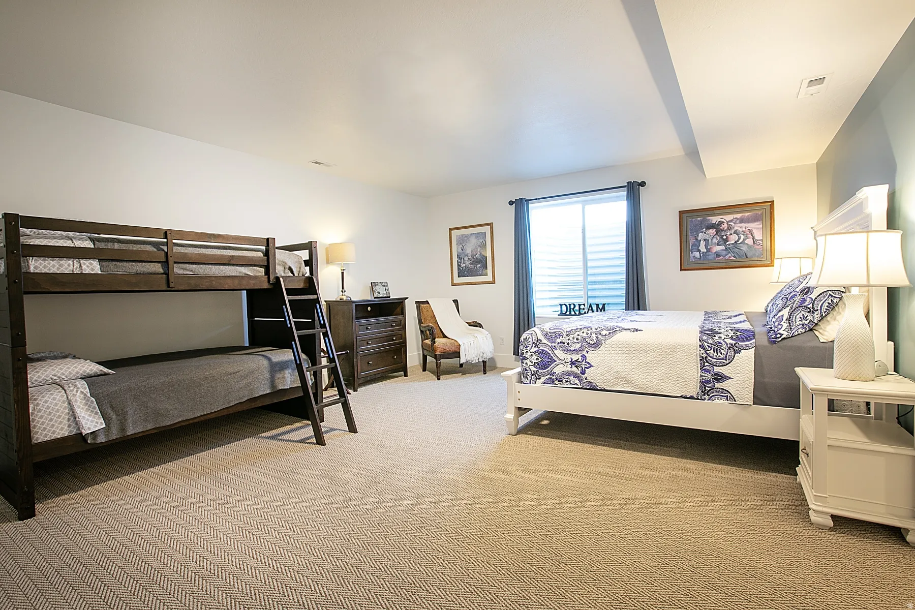 Carpeted room featuring white walls, a single window with blinds and blue curtains, and a painted accent wall