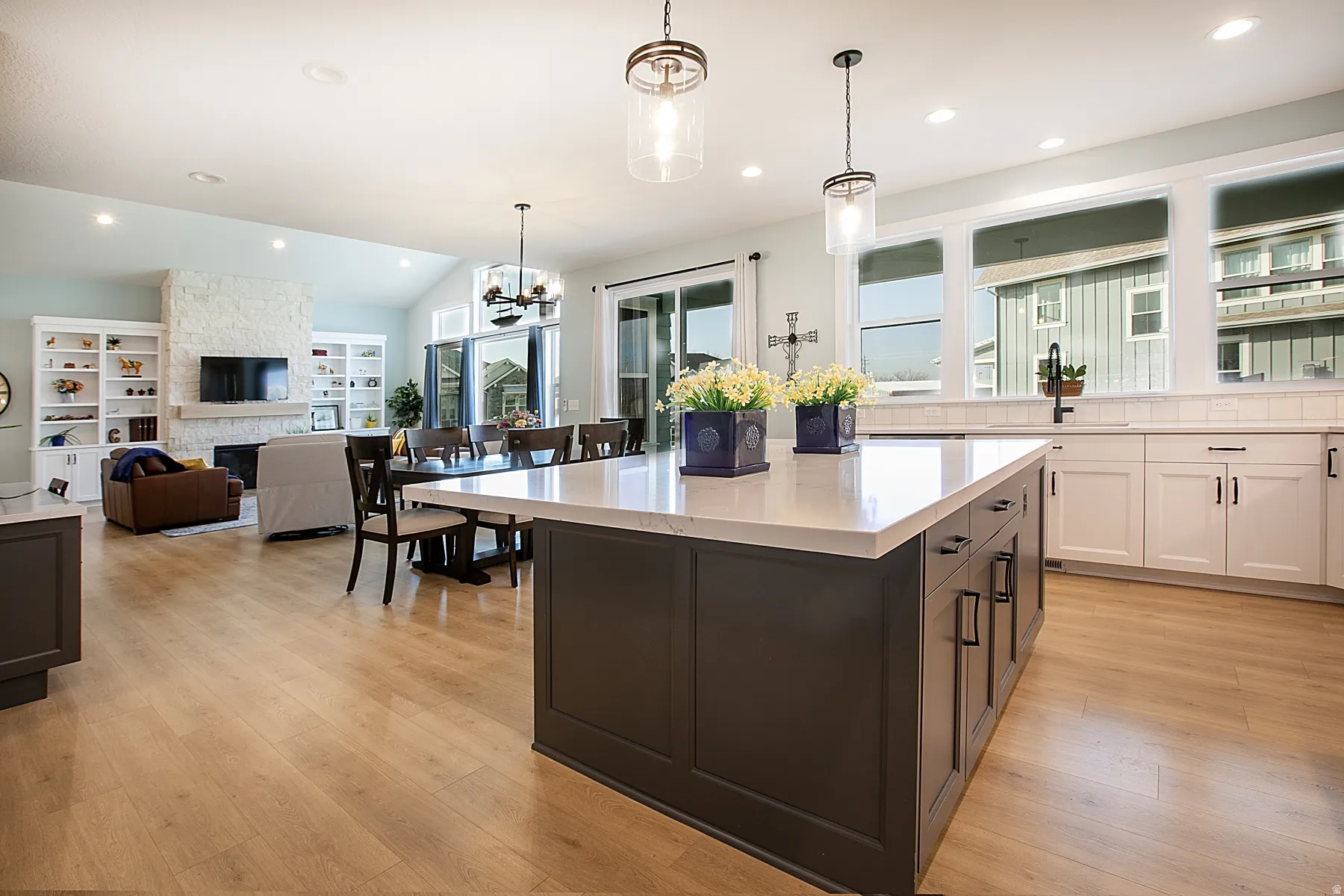 Expansive kitchen island with a light-toned countertop and dark cabinetry