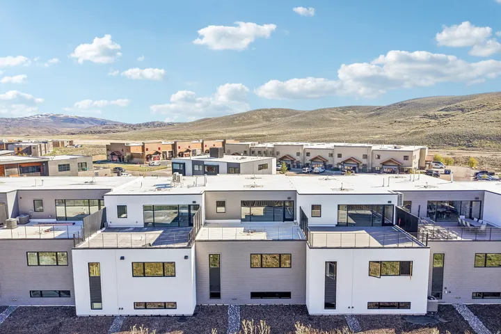 Contemporary multi-story residences featuring flat roofs and expansive outdoor deck spaces
