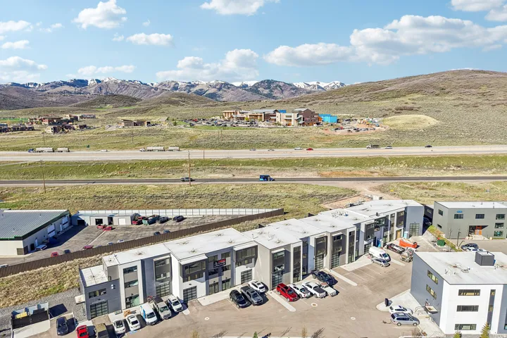 Modern mixed-use development featuring individual garage doors and large windows